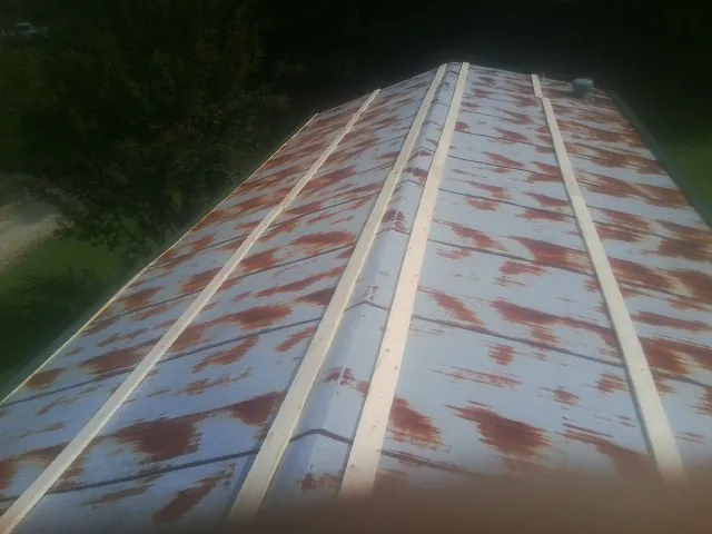 Rusted metal roof panels with new wood purlins before replacement — Storm Damage Roof Repair in Canisteo by Roofing Brothers
